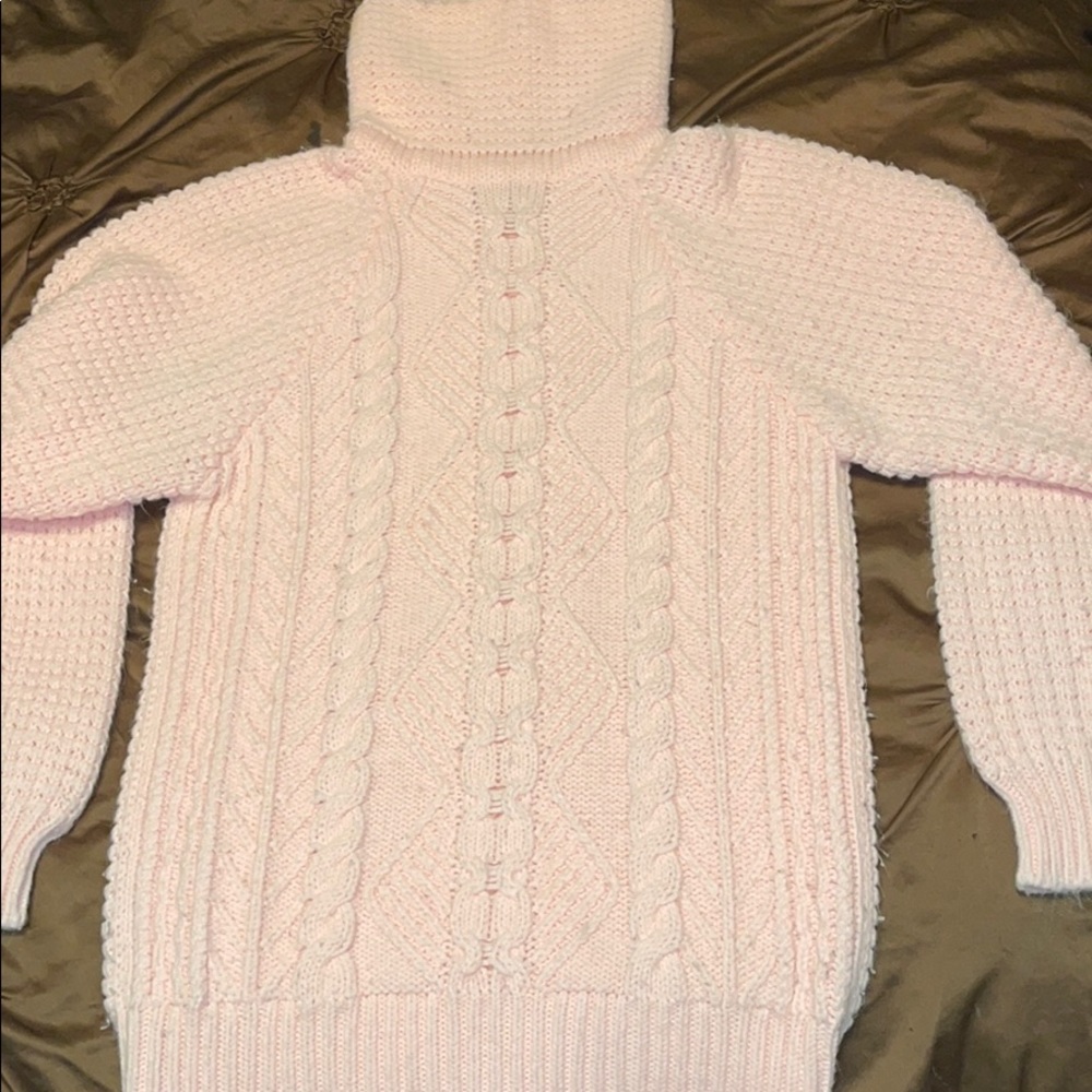 Woman’s pastel pink turtle neck sweater